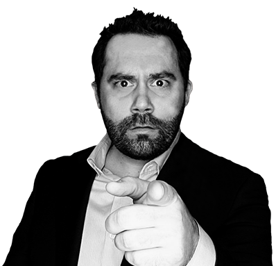 Joey Trimmer in a suit pointing at you